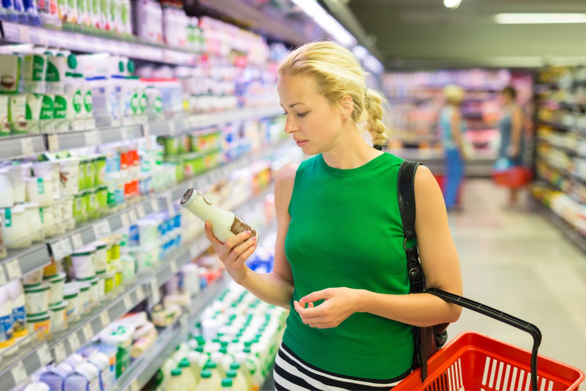 Mother reading food labels to assess salt intake for her baby