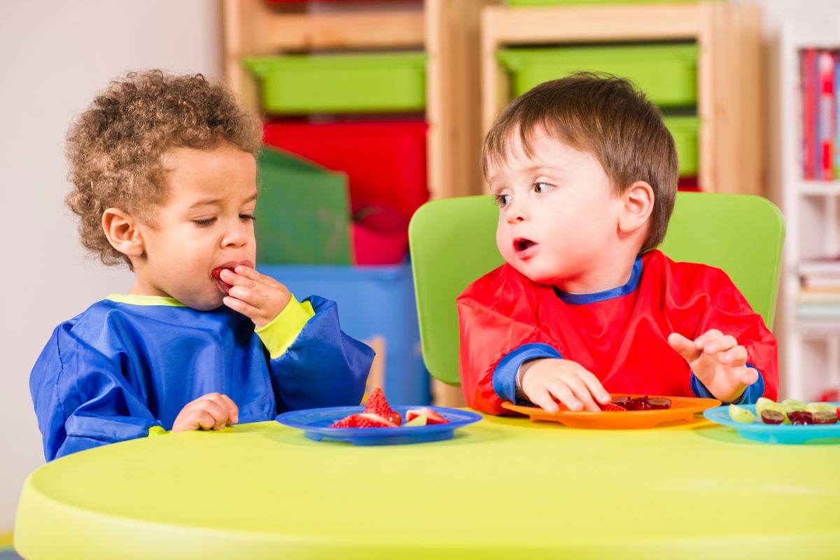 Toddler sharing fruit as a snack at creche