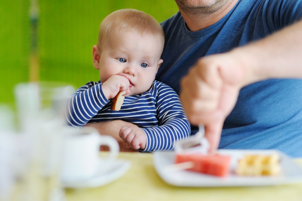 Baby eating a crust of bread